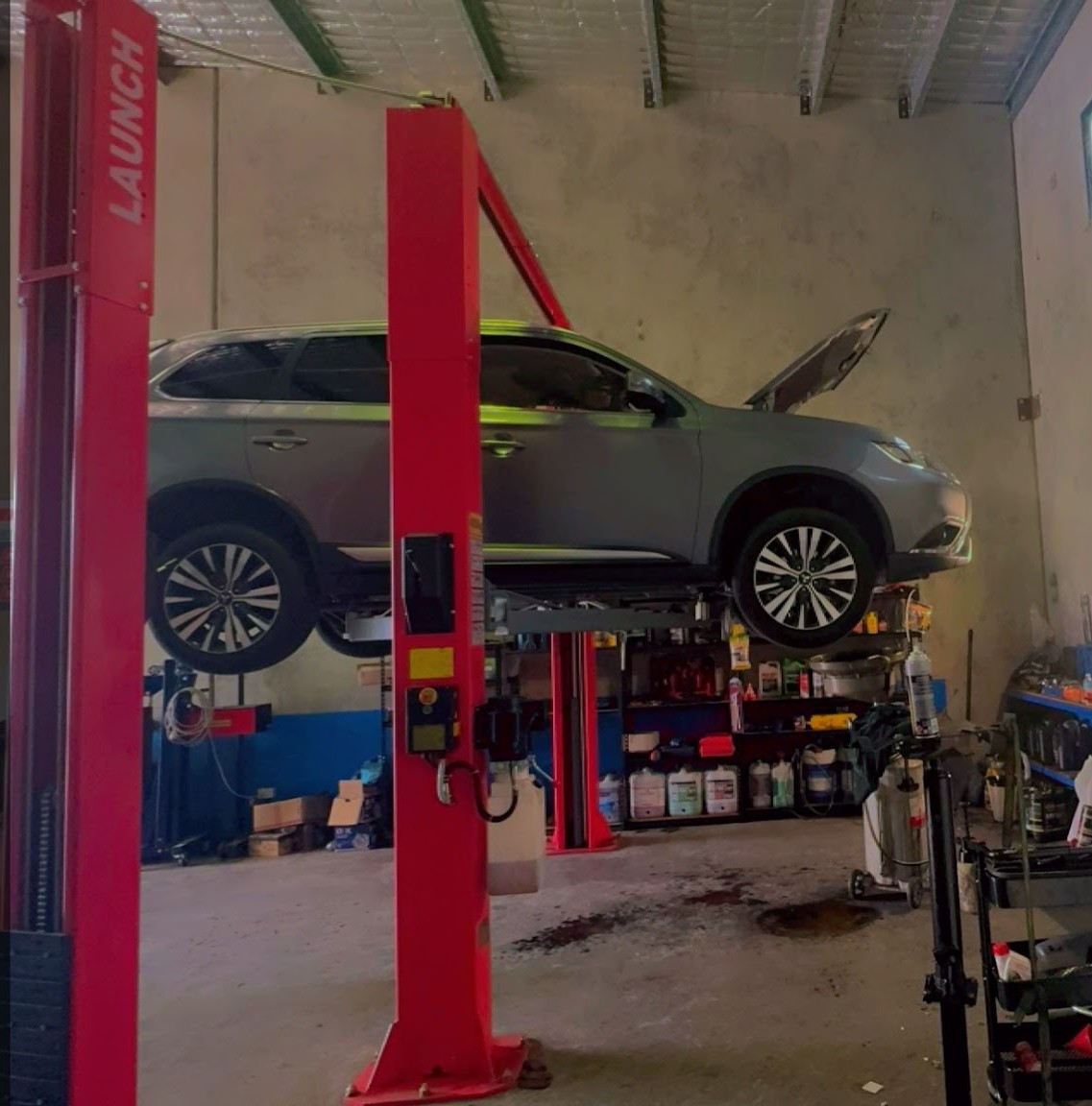 A Mitsubishi Outlander raised on the red Launch two post hoist at Jimboomba Autocare