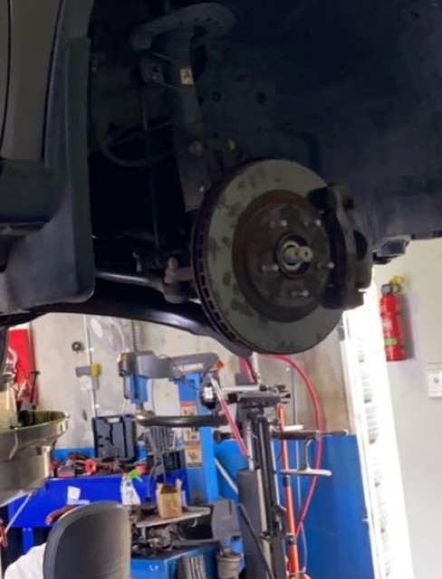 A Nissan X-Trail on the hoist at Jimboomba Autocare with the wheel off and the brake disc exposed