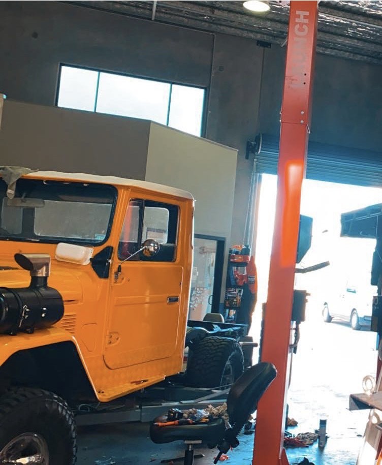 A restored orange Toyota Land Cruiser FJ40 in for work at Jimboomba Autocare