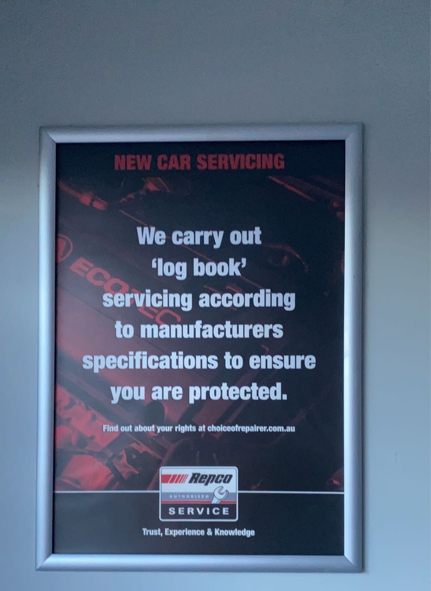 The Repco Authorised Service log book servicing notice on the wall of the Jimboomba Autocare workshop